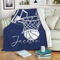 Navy basketball throw blanket draped over a couch with a hoop, net, and basketball design