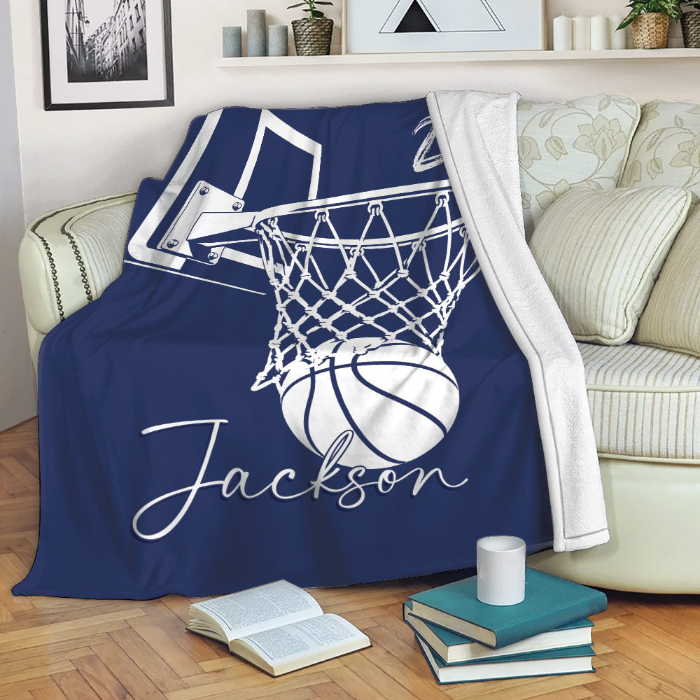 Navy basketball throw blanket draped over a couch with a hoop, net, and basketball design