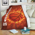 Basketball throw blanket draped over a sofa with fiery orange artwork and bold sports styling