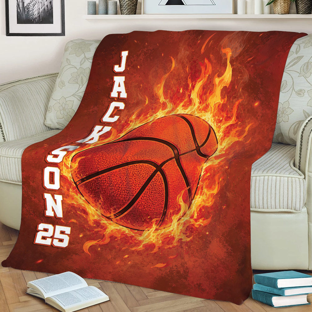 Red basketball throw blanket displayed on a sofa with flaming basketball artwork