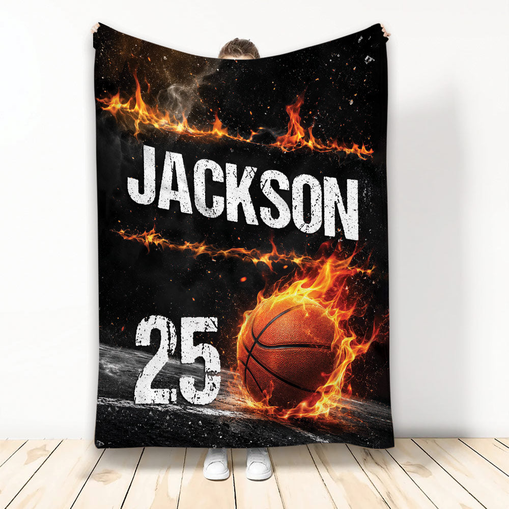 Basketball throw blanket with a fiery basketball design shown being held upright