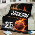 Basketball throw blanket with dramatic fire artwork styled on a sofa