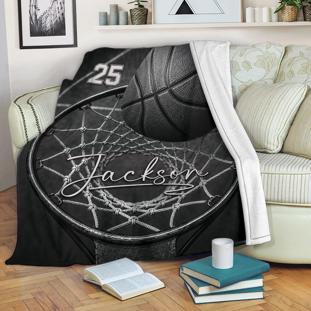 Black and white basketball blanket displayed on a sofa with hoop and net artwork