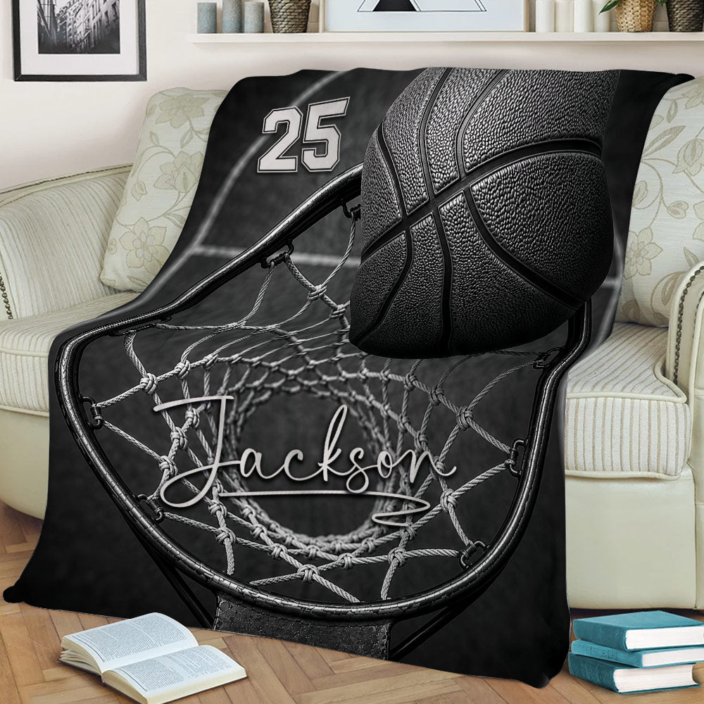 Basketball throw blanket draped over a couch with bold hoop, net, and court design