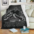 Black hockey goalie throw blanket styled on a cozy living room sofa