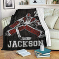Hockey goalie throw blanket draped over a couch with bold red, black and white sports artwork