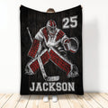 Hockey throw blanket displayed upright with red and black goalie artwork on a dark woodgrain background