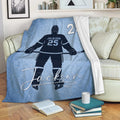Custom hockey throw blanket displayed on a sofa with icy blue player artwork
