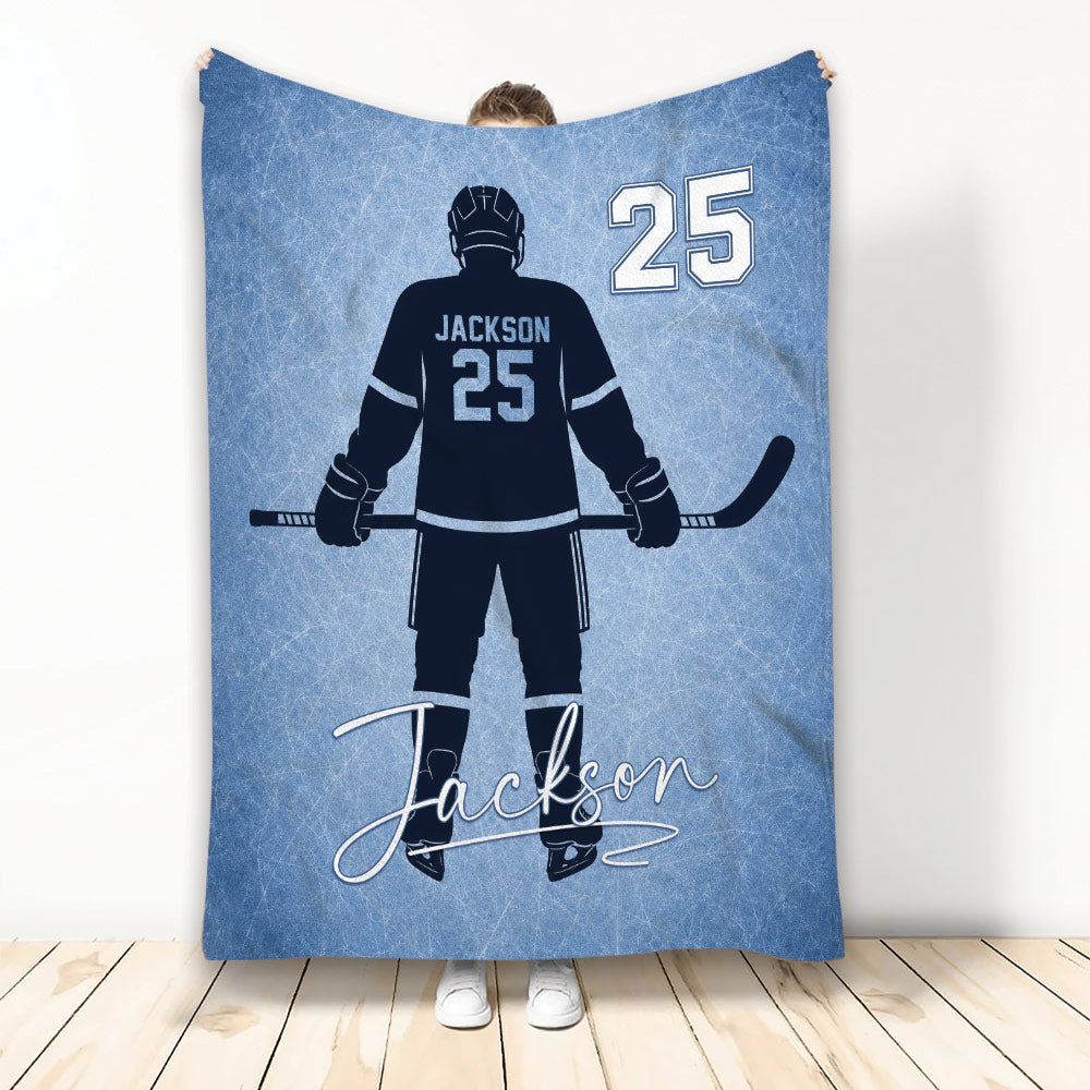 Blue hockey blanket featuring an ice hockey player silhouette with stick and skates