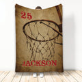 Basketball throw blanket with vintage sepia hoop and net artwork displayed against a wall
