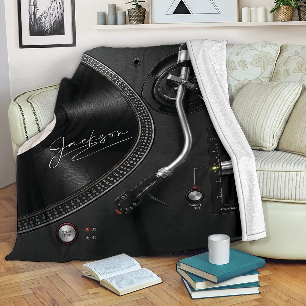 DJ blanket displayed over a sofa with turntable and vinyl record artwork in a stylish living room
