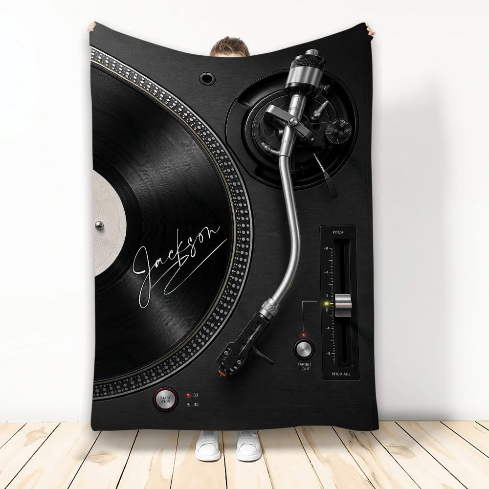 DJ throw blanket featuring a black turntable, vinyl record, and silver tonearm in a dramatic music design