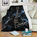 Guitar throw blanket draped over a sofa with black, blue and electric lightning artwork