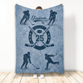 Blue hockey throw blanket featuring illustrated players, crossed hockey sticks, puck, and vintage sports artwork