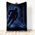 Blue and black hockey blanket featuring a helmeted ice hockey player silhouette and bold sports artwork