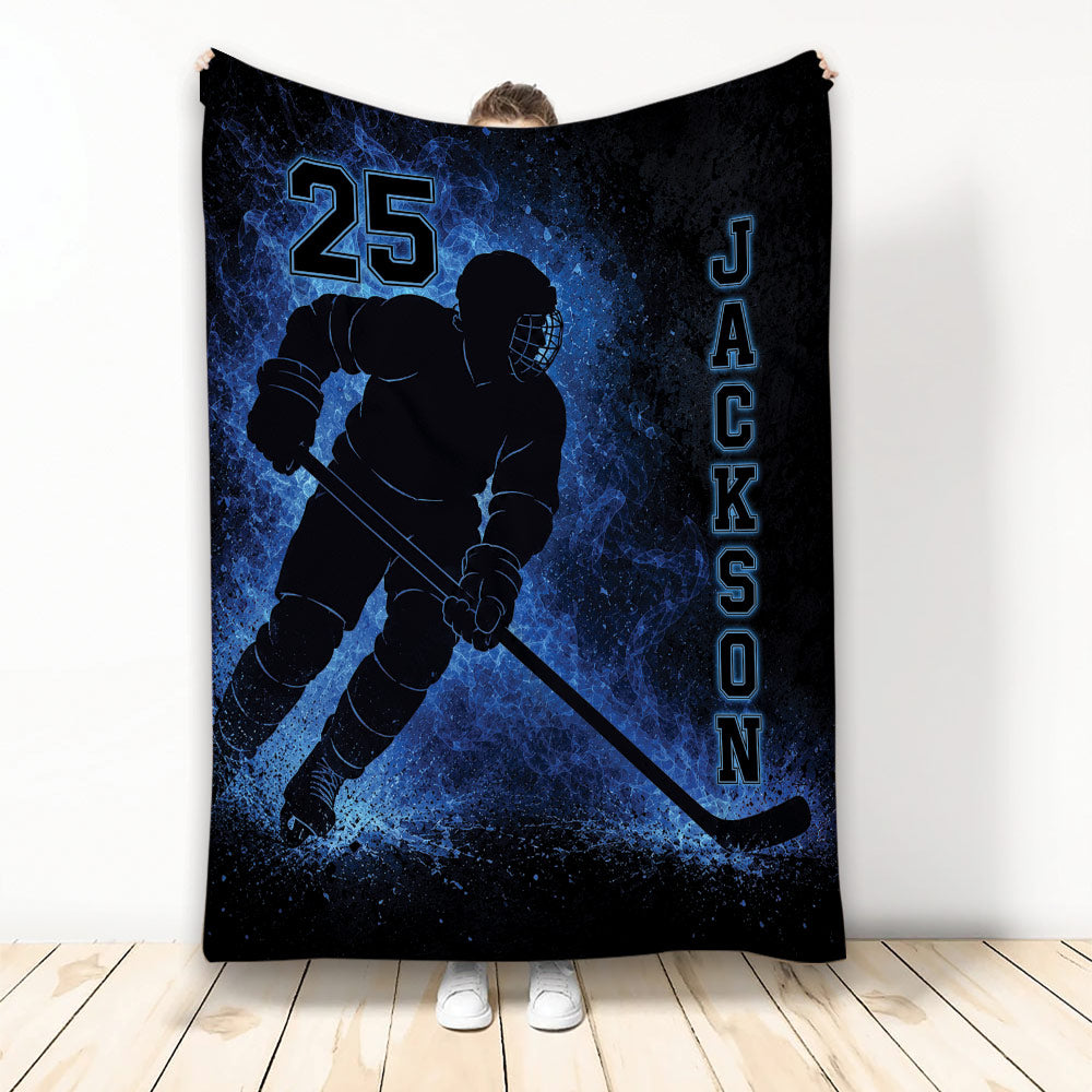 Blue and black hockey blanket featuring a helmeted ice hockey player silhouette and bold sports artwork