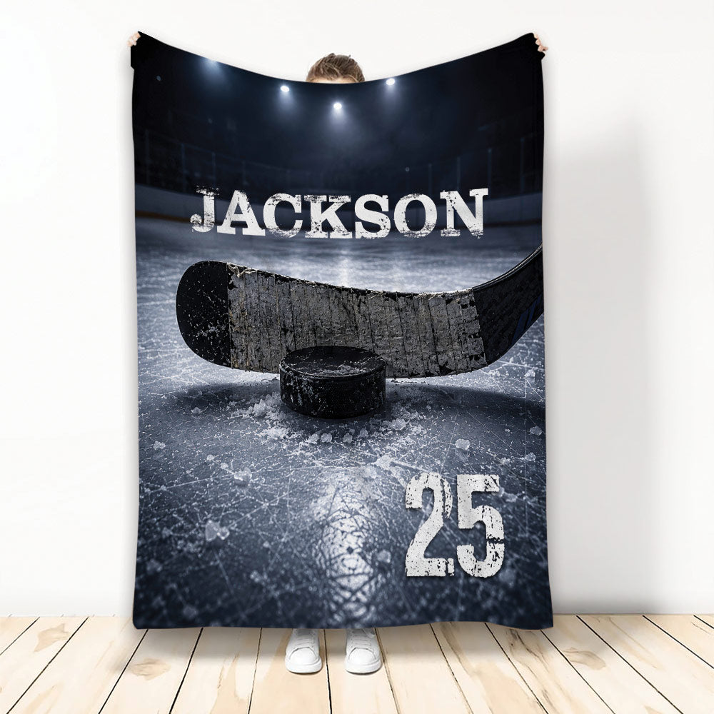 Hockey throw blanket displayed with a hockey stick, puck, ice rink artwork, and dark arena lighting