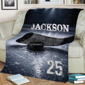 Hockey throw blanket styled on a sofa with dramatic ice rink, stick, and puck artwork