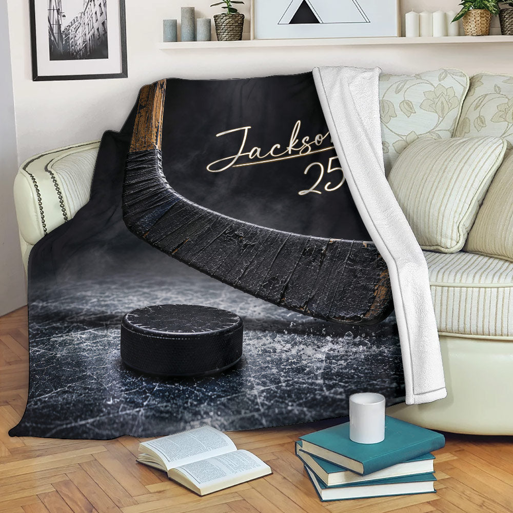 Hockey throw blanket styled on a sofa with hockey stick and puck artwork