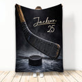 Hockey blanket displayed with a dramatic hockey stick and puck on an icy black background