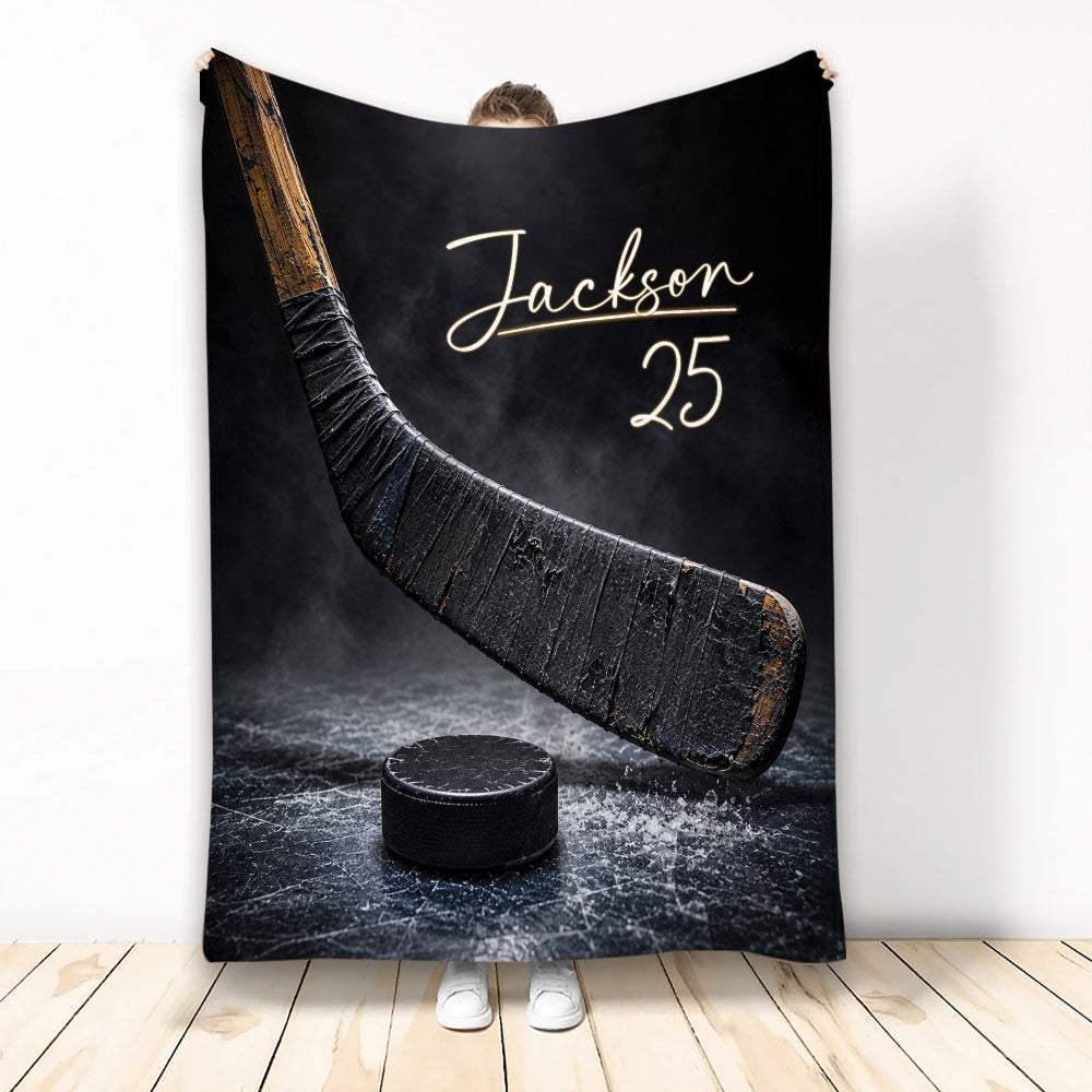 Hockey blanket displayed with a dramatic hockey stick and puck on an icy black background