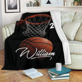 Basketball blanket draped over a sofa with hoop and ball artwork in a cozy room