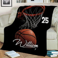 Basketball throw blanket displayed on a sofa with dramatic hoop and ball design