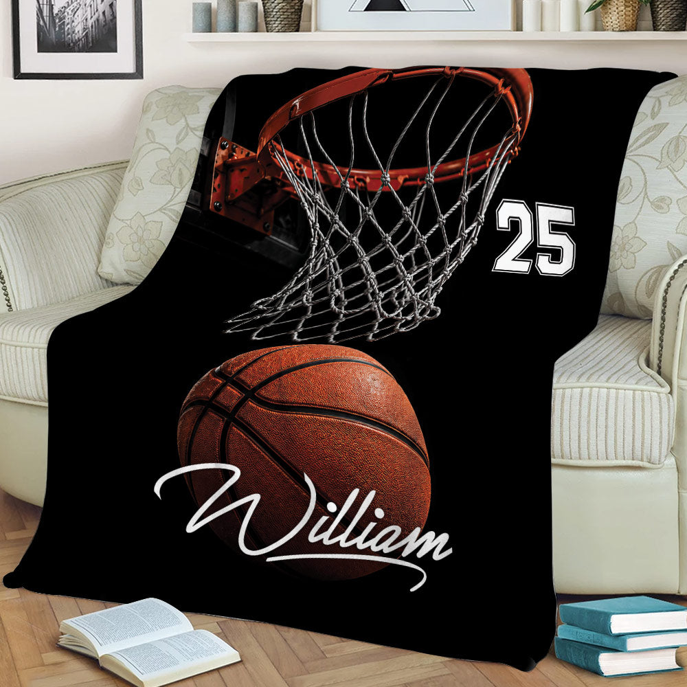 Basketball throw blanket displayed on a sofa with dramatic hoop and ball design