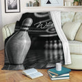 Bowling throw blanket draped over a sofa featuring a metallic bowling pin and dark bowling alley design