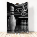 Black and white bowling throw blanket displayed vertically with a large bowling pin and bowling alley artwork
