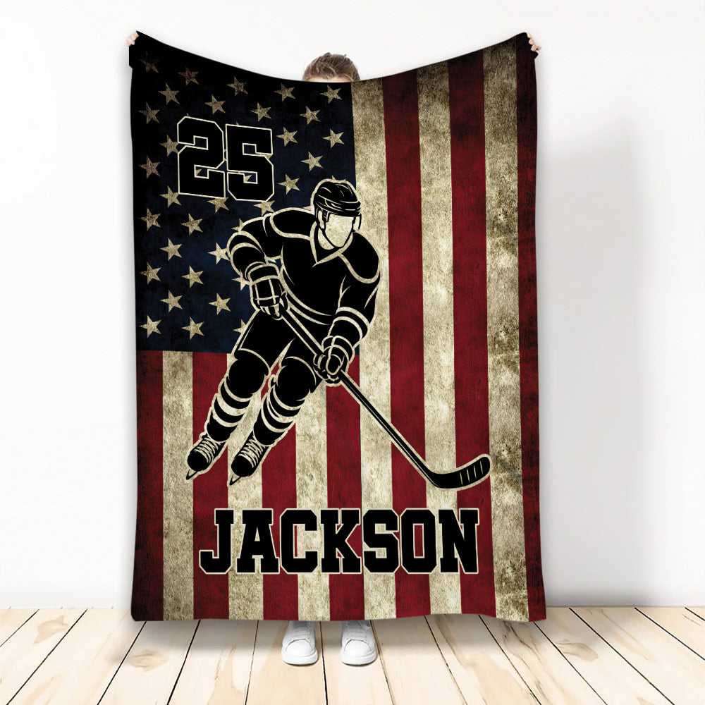Patriotic hockey blanket featuring a skating player silhouette against stars and distressed red and white stripes