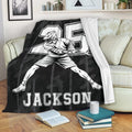 Lacrosse player throw blanket displayed on a sofa with black camouflage sports artwork and bold graphic styling