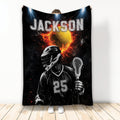 Custom lacrosse blanket featuring a helmeted player with stick, fiery ball artwork, and dramatic black sports design
