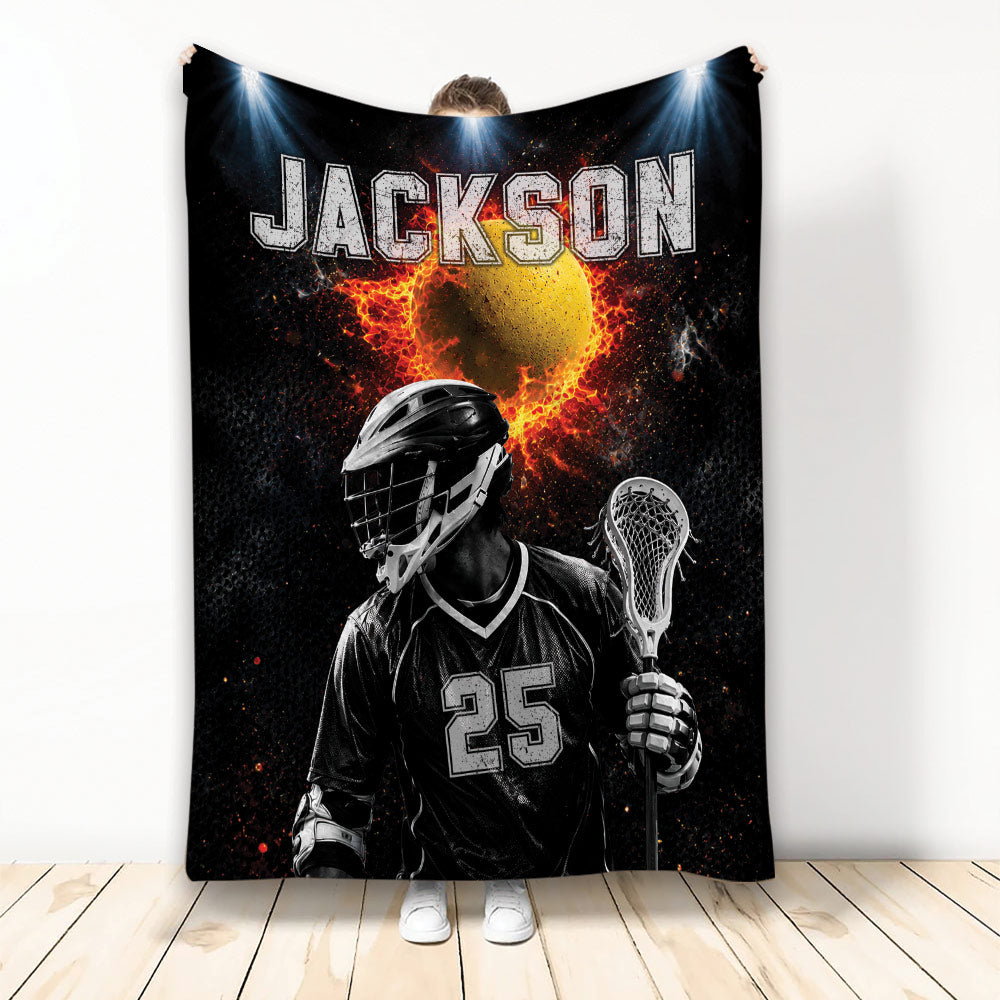 Custom lacrosse blanket featuring a helmeted player with stick, fiery ball artwork, and dramatic black sports design