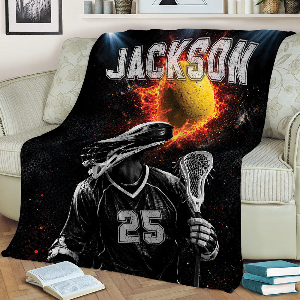 Lacrosse throw blanket styled on a couch, featuring a helmeted player, stick, ball, and bold black and red design