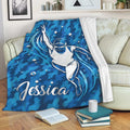 Swimming throw blanket displayed on a sofa with blue underwater swimmer artwork