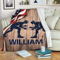 Wrestling blanket displayed on a sofa with grappler artwork, wood texture, and American flag accents