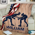 Rustic wrestling throw blanket draped over a couch with two wrestler silhouettes and patriotic artwork