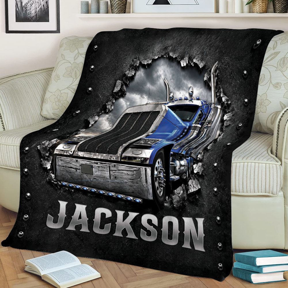 Detailed big rig truck artwork on a black throw blanket draped over a couch