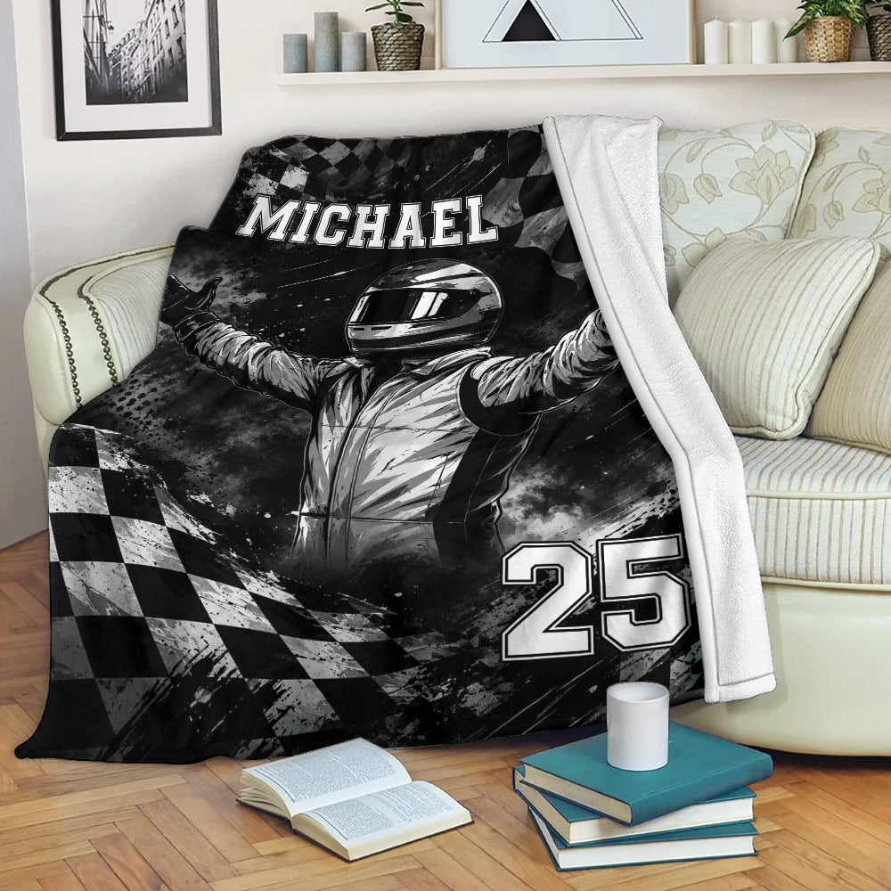 Racing throw blanket displayed on a sofa with a helmeted driver and bold monochrome checkered design