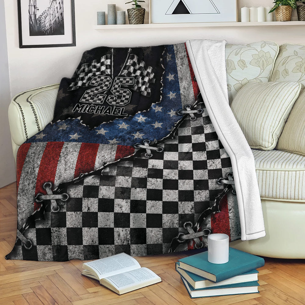 Custom racing throw blanket displayed on a sofa with checkered flag and bold red, white, and blue artwork