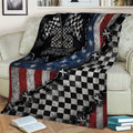 Racing blanket draped over a couch, featuring checkered flags and rugged patriotic motorsport artwork