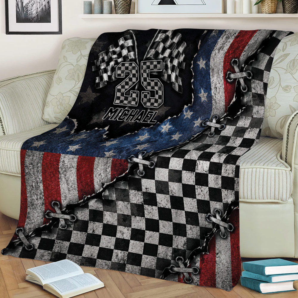Racing blanket draped over a couch, featuring checkered flags and rugged patriotic motorsport artwork