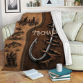 Rustic fishing throw blanket displayed on a sofa with anglers, fish and hook artwork