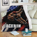 Wrestling blanket draped across a couch with dynamic grappling artwork and patriotic-inspired colors