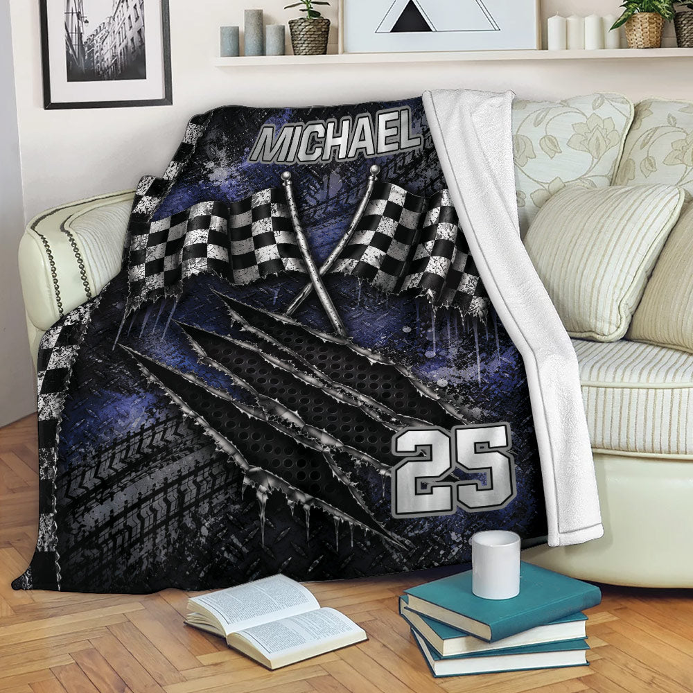 Racing blanket draped over a sofa with checkered flags and rugged tire-track graphics