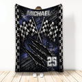 Racing throw blanket with checkered flags, tire tracks, and bold blue and black motorsport artwork