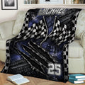 Motorsport throw blanket displayed on a couch with waving checkered flags and dark racing artwork