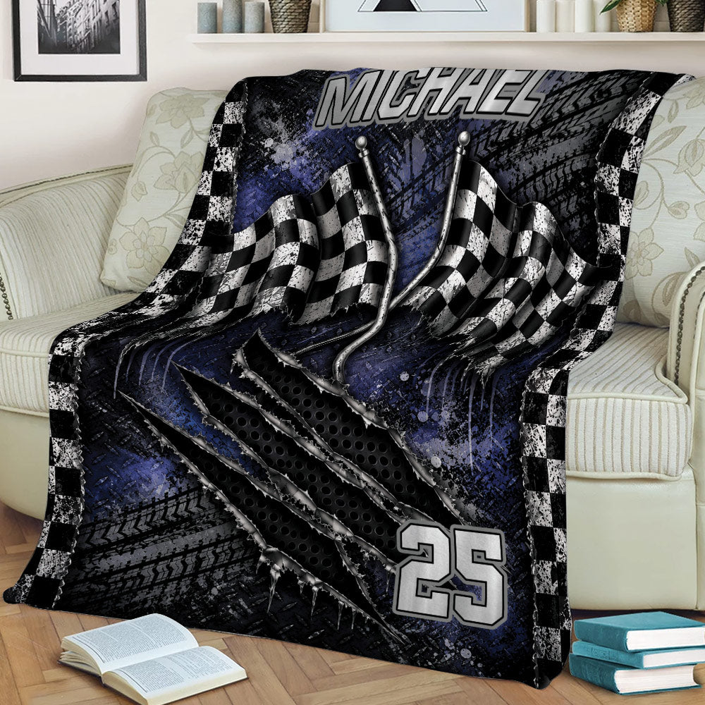 Motorsport throw blanket displayed on a couch with waving checkered flags and dark racing artwork