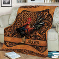 Rooster chicken blanket draped over a couch, featuring rich brown tones, floral ornament, and detailed bird artwork